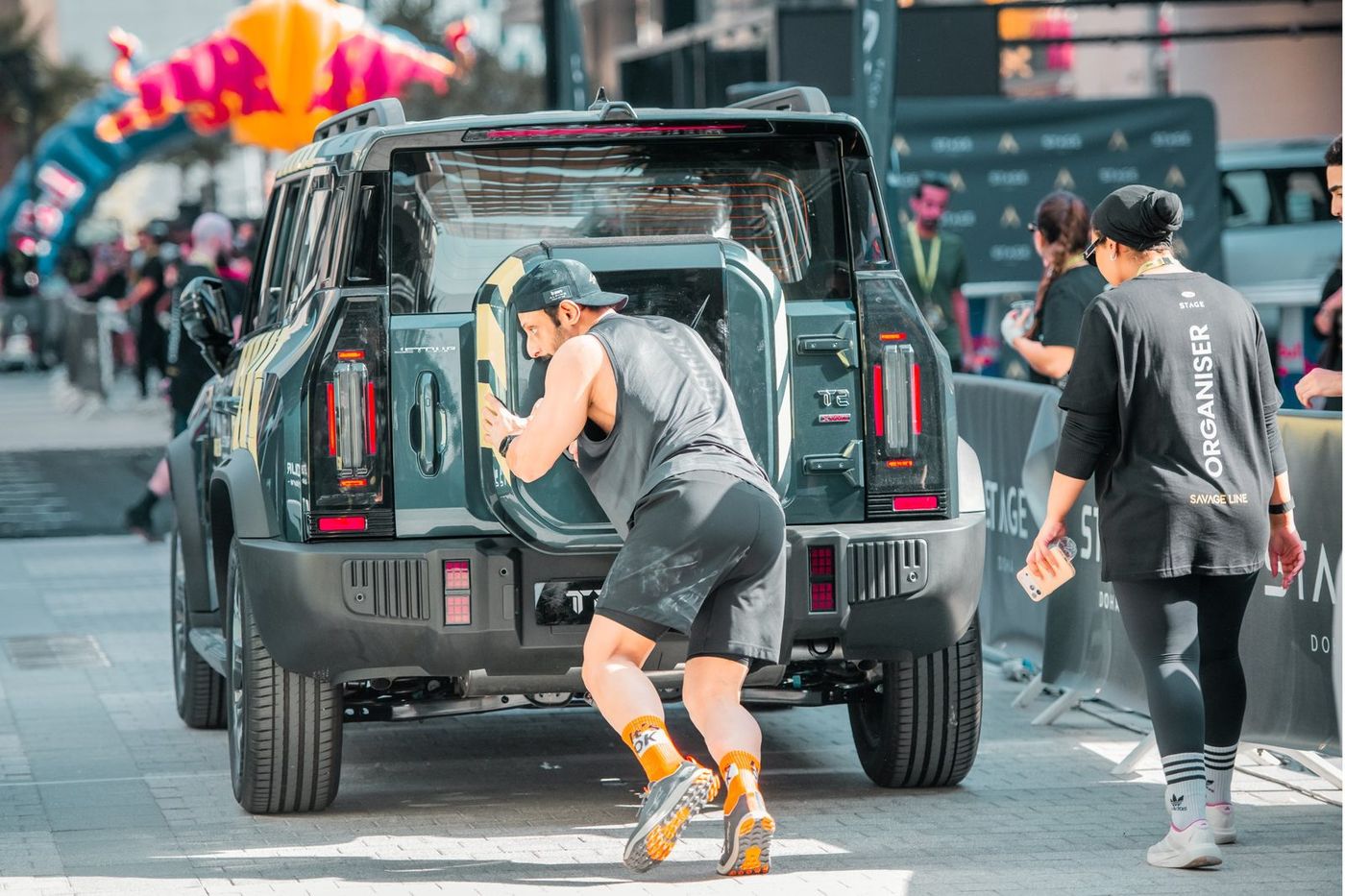 A competitor pushing a car at Savage Line 2026