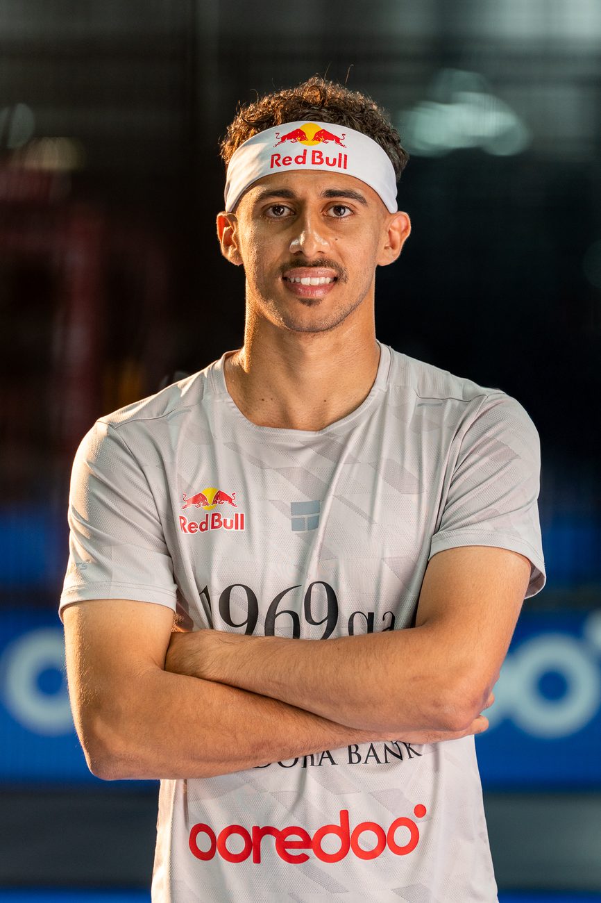 Portrait of Rashed Nawaf, arms crossed, in a Red Bull headband